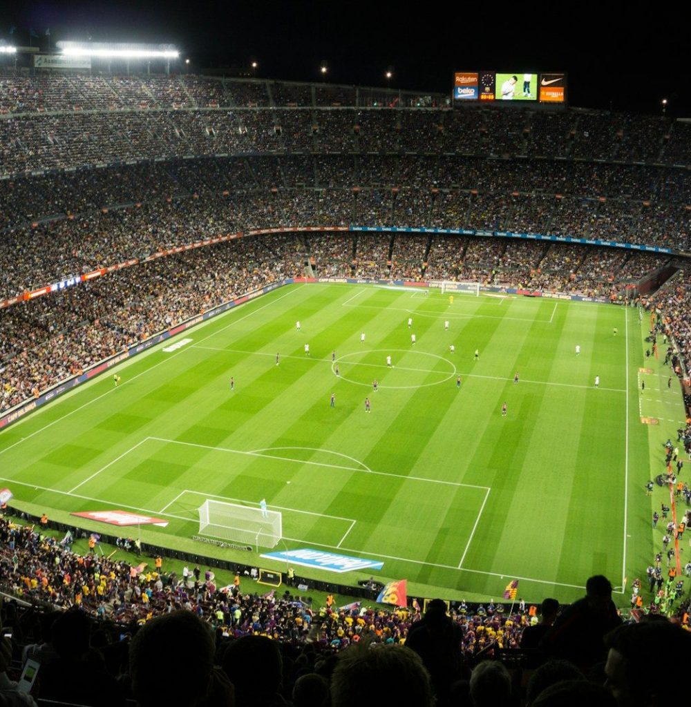 people watching soccer game in stadium