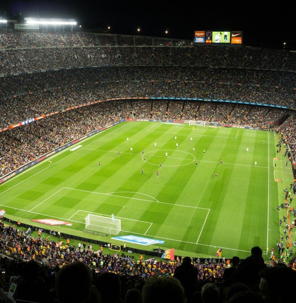 people watching soccer game in stadium