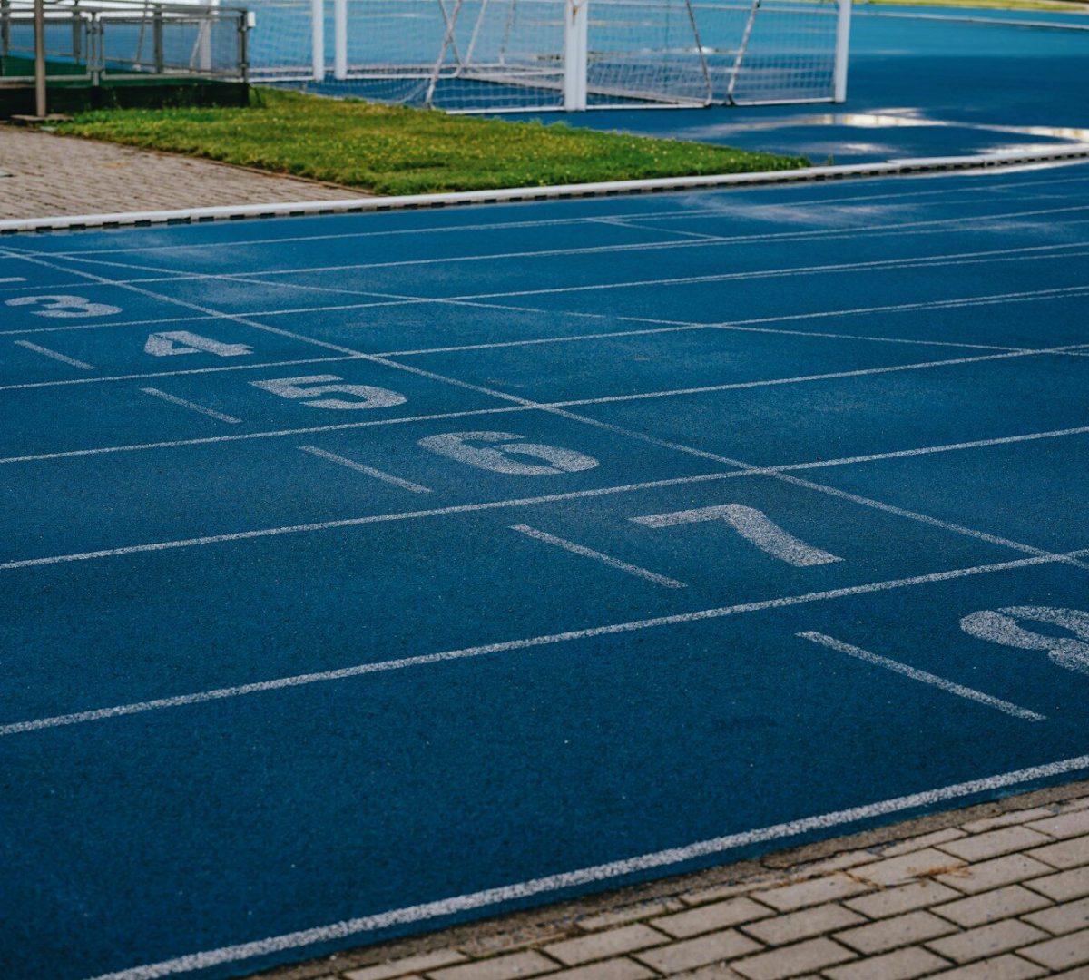 a blue tennis court with numbers painted on it